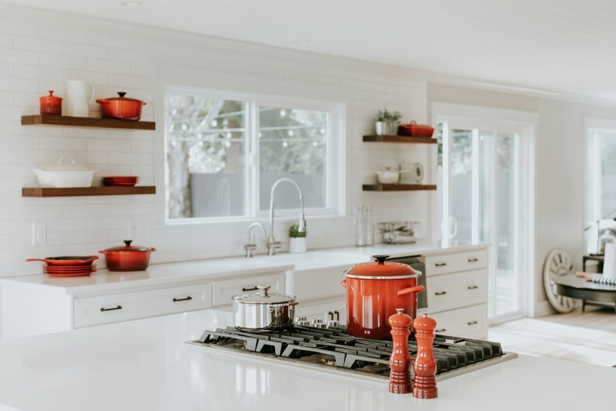Bright white kitchen with open shelves and freshly finished walls