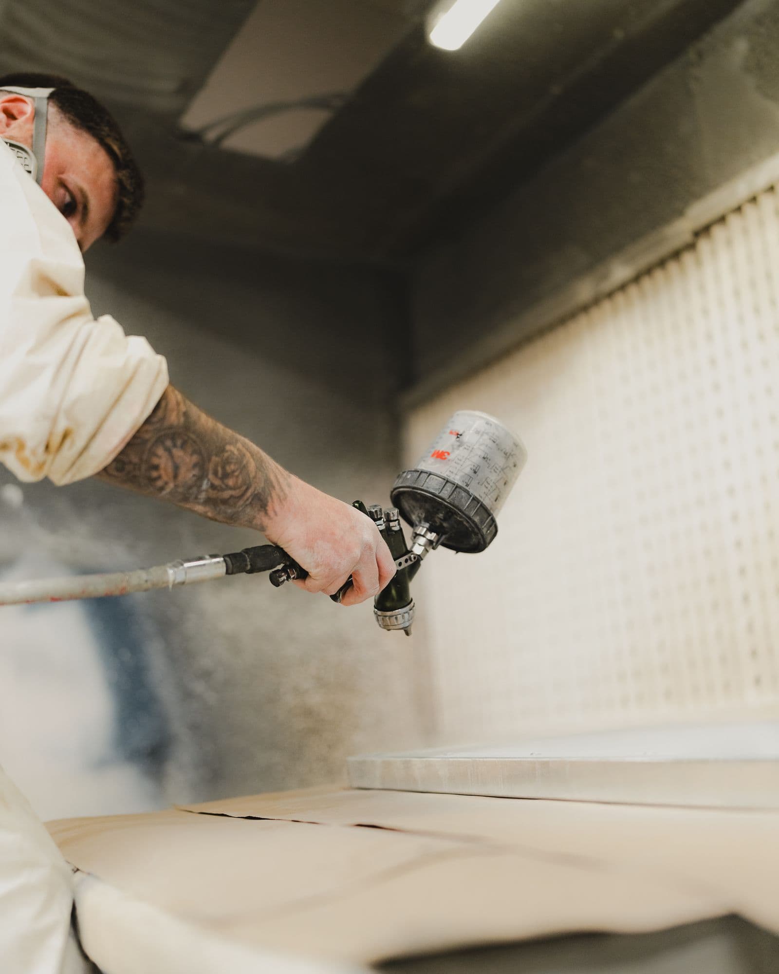 Painter spraying a surface with an HVLP spray gun
