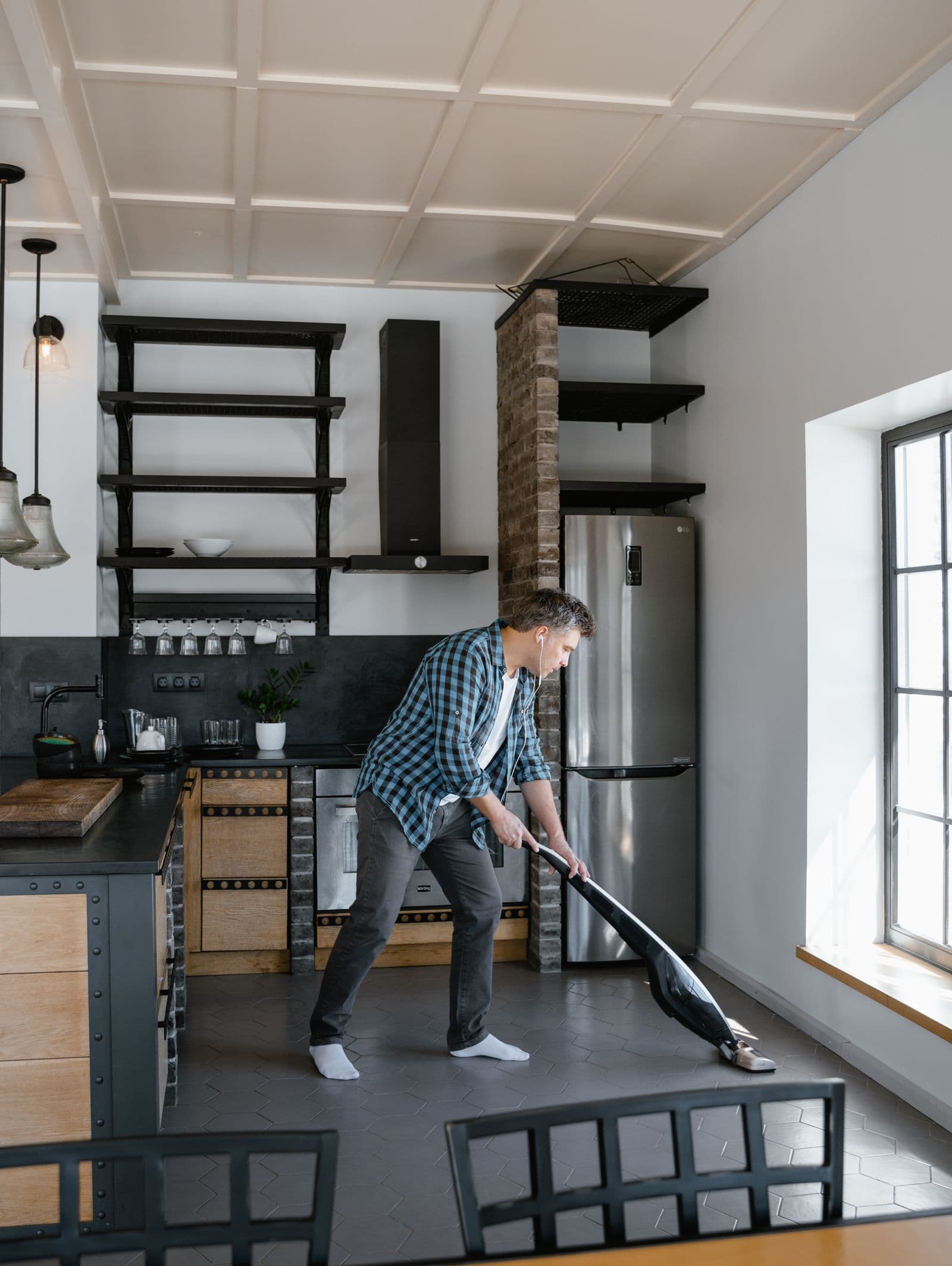 Vacuuming a kitchen floor after work